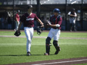 Ridgefield Raptors starting pitcher Curtis Hebert, left, is congratulated by catcher Justin Stransky after a strikeout during a West Coast League baseball game against the Corvallis Knights on Thursday, July 4, 2024 at Ridgefield Outdoor Recreation Complex.