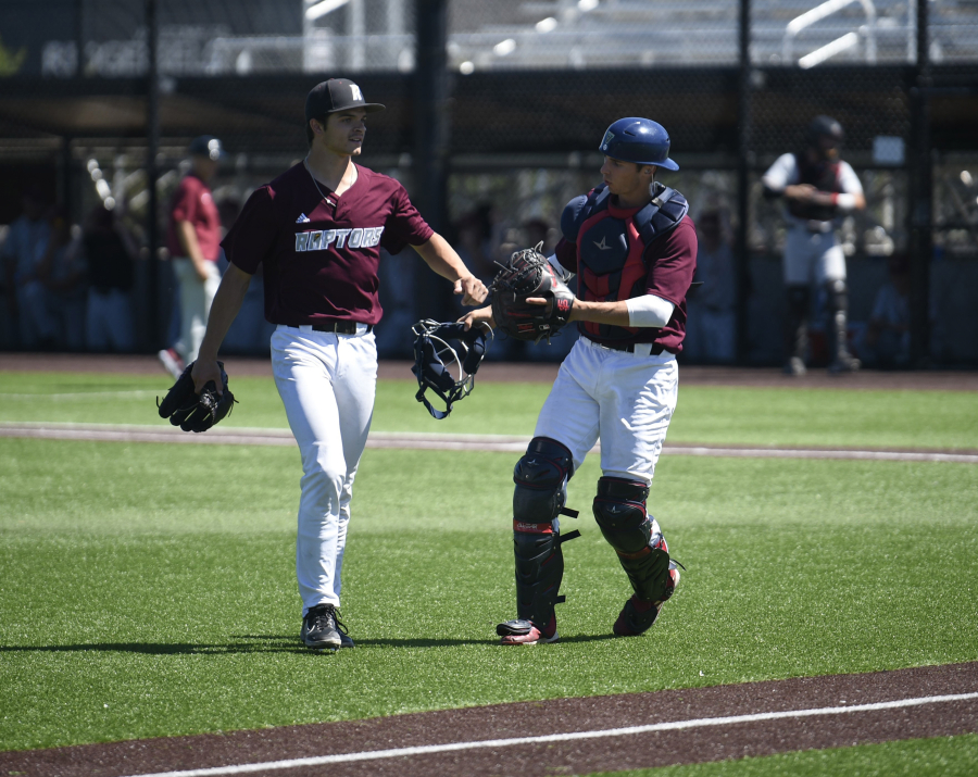 Ridgefield Raptors starting pitcher Curtis Hebert, left, is congratulated by catcher Justin Stransky after a strikeout during a West Coast League baseball game against the Corvallis Knights on Thursday, July 4, 2024 at Ridgefield Outdoor Recreation Complex.