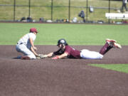 Ridgefield Raptors baserunner Hunter Katschke, right, is tagged out trying to steal second base by Corvallis Knights shortstop Ty Yukumoto during a West Coast League baseball game on Thursday, July 4, 2024 at Ridgefield Outdoor Recreation Complex.