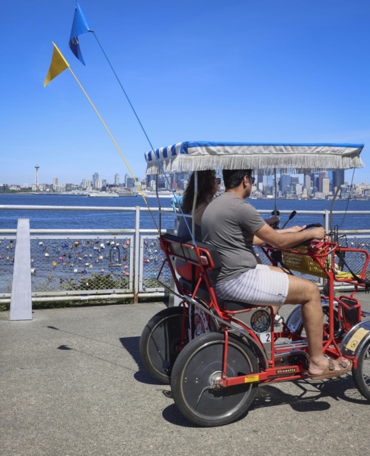 People ride tandem bikes May 10 near Alki Beach in Seattle.