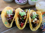 Ancho-spiced beef tacos with grilled pineapple salsa and salsa verde.