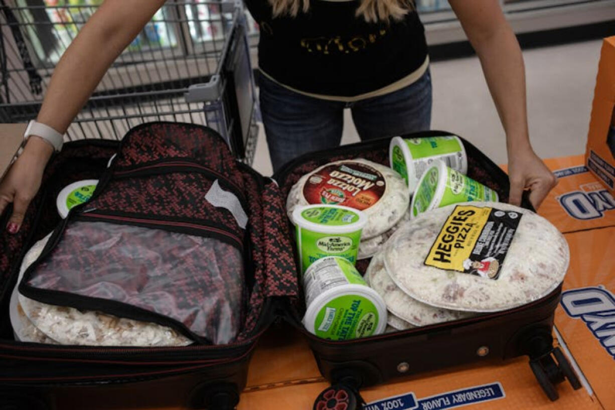 At Cub Foods in Forest Lake, Tina Fisher makes sure her stash of Top the Tater and Heggie&rsquo;s Pizza, Minnesota-made foods her family can&rsquo;t get in Florida, will fit in her suitcase when she flies home.