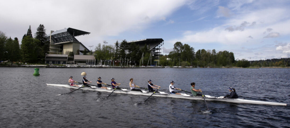 An eight-person rowing team practices on Lake Washington before the Windermere Cup in Seattle. Former University of Washington rowers will be competing for several nations at the Paris Olympics, including the United States, Great Britian, Italy, Germany and New Zealand.