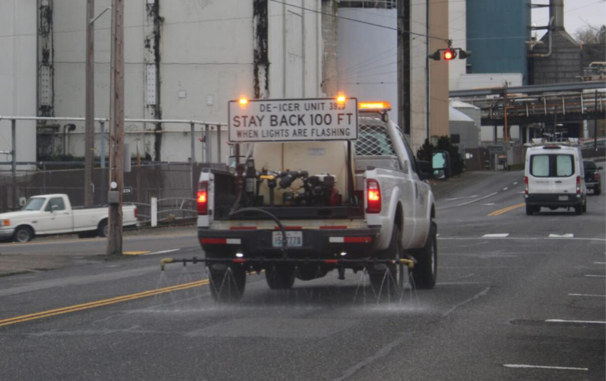 A de-icing truck drives through Camas in January.