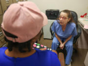 Sherri Loss, right, a LPN who came out of retirement during the pandemic to work at the East Cypress Women&rsquo;s Center, has a consultation session with a patient during a busy morning at the clinic on Monday, April 24, 2023.