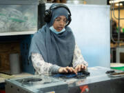 University of Minnesota, Duluth master&rsquo;s student Hira Durrani feeds a piece of fabric into the Fiber Shredder machine on July 10. The machine was developed by Abigail Clarke-Sather and her team.