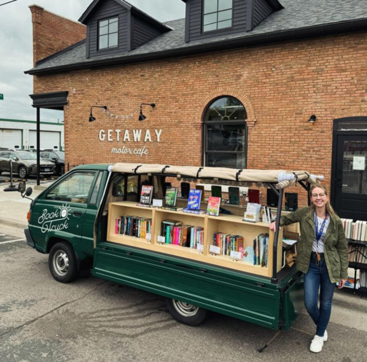 Rachel Cleveland opens her Little Charity Book Truck for sales in Minneapolis. The truck buys new books at a discount, sells them at list price and gives 40 percent of the proceeds to two charities.