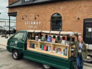 Rachel Cleveland opens her Little Charity Book Truck for sales in Minneapolis. The truck buys new books at a discount, sells them at list price and gives 40 percent of the proceeds to two charities.