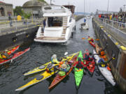 Kayaks join boats in the Ballard Locks in Seattle.