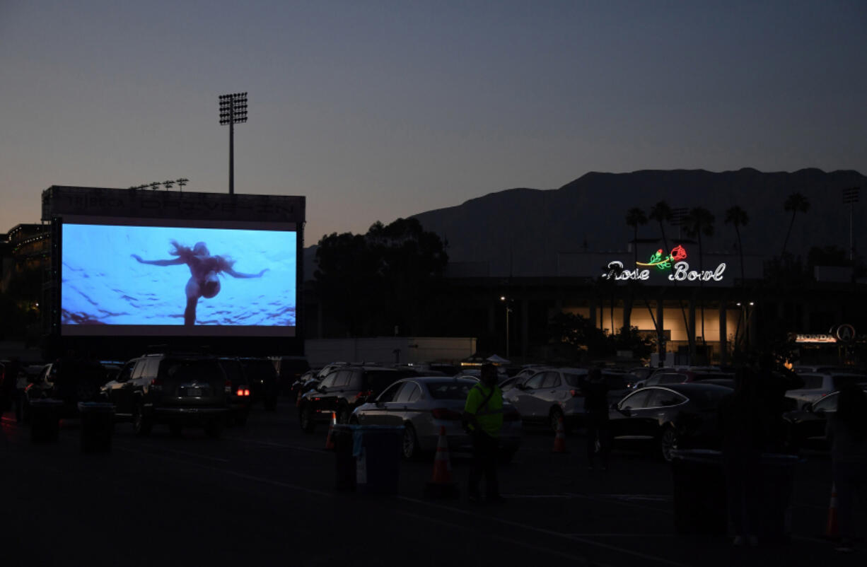 People watch &ldquo;Jaws&rdquo; as part of the Tribeca Film Festival&rsquo;s drive-in movie series July 2, 2020, amid the COVID-19 pandemic at the Rose Bowl in Pasadena, Calif.