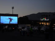 People watch &ldquo;Jaws&rdquo; as part of the Tribeca Film Festival&rsquo;s drive-in movie series July 2, 2020, amid the COVID-19 pandemic at the Rose Bowl in Pasadena, Calif.