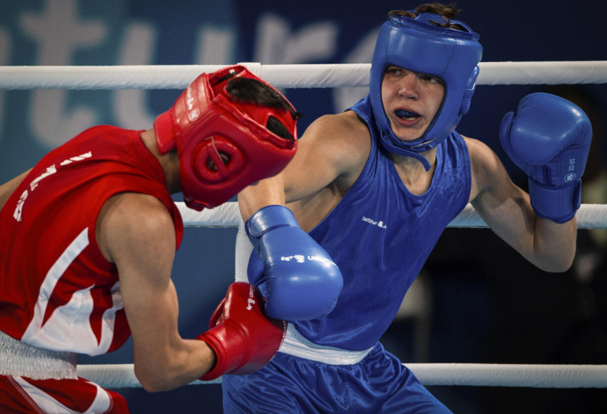 Maksym Halinichev of Ukraine, right, competes Oct. 18, 2018, against Abdumalik Khalokov of Uzbekistan in the Boxing Men&rsquo;s Bantam (56kg) Gold Medal Bout at the Oceania Pavilion of Youth Olympic Park during the Youth Olympic Games in Buenos Aires, Argentina. As one of Ukraine&rsquo;s most promising boxing prospects, Halinichev could have been shielded from the war.