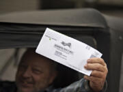 Vancouver resident Larry Hellstrom displays his ballot before dropping it off downtown Thursday afternoon, Oct. 29, 2020.