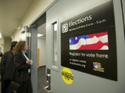 Clark County residents wait outside the elections office to fill out absentee ballots, register to vote or ask election day questions at the Clark County Elections office Tuesday November 6, 2012 in Vancouver, Washington.