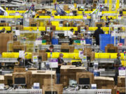 Employees at packing stations are seen at Amazon&rsquo;s Kent, Washington, fulfillment center on June 11, 2020.