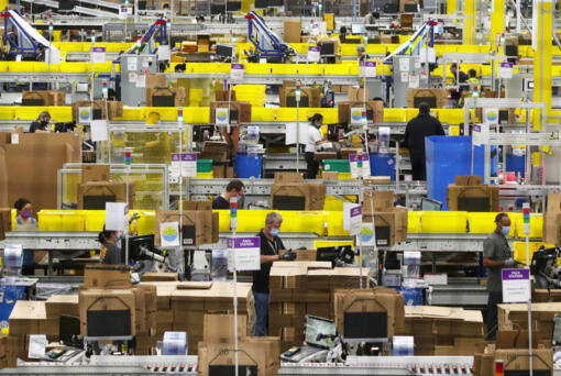 Employees at packing stations are seen at Amazon&rsquo;s Kent, Washington, fulfillment center on June 11, 2020.
