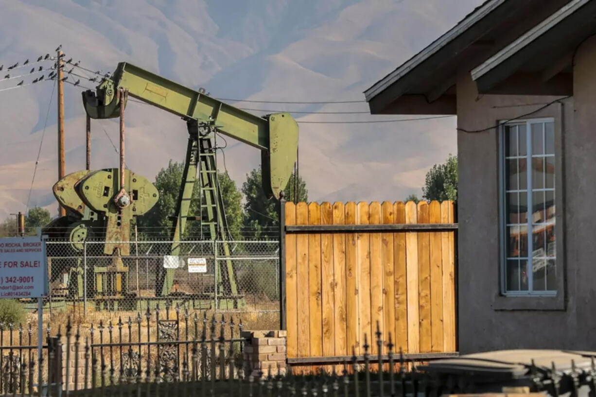 A pumpjack sits near homes in Arvin, California.