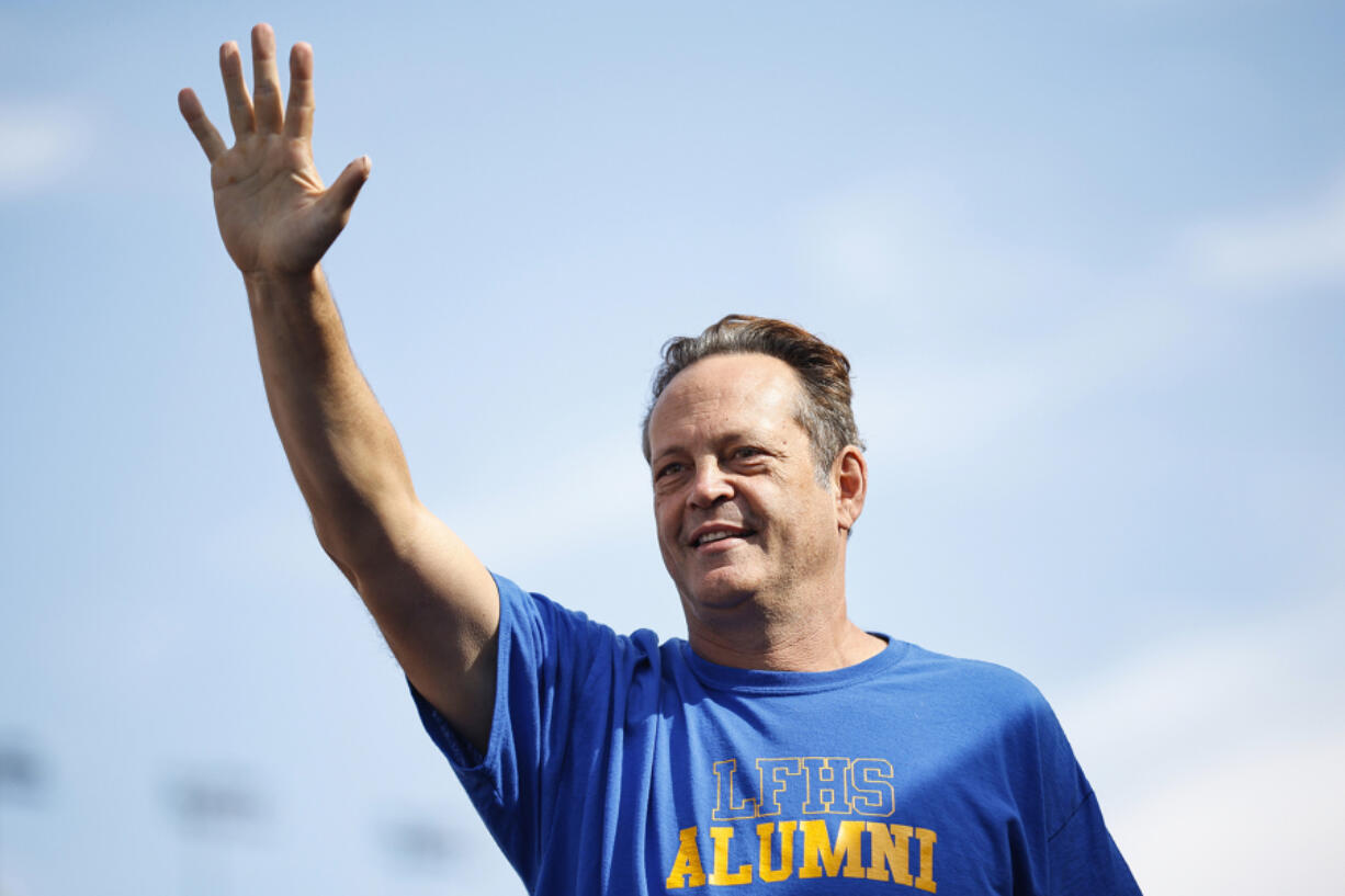 Actor Vince Vaughn waves to fans as he walks onstage during driver pre-race ceremonies prior to the NASCAR Cup Series South Point 400 at Las Vegas Motor Speedway on Oct. 16, 2022, in Las Vegas, Nevada.