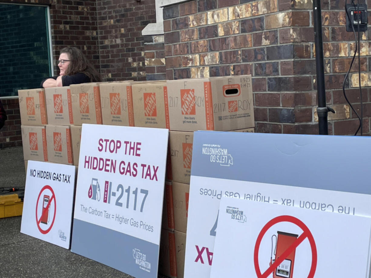 Let&rsquo;s Go Washington, a political committee, turned in boxes of petitions for Initiative 2117 (above) and five other initiatives in the fall of 2023. A supporter rests before helping deliver them to the secretary of state&rsquo;s office.