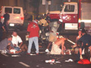 People tend to the injured after an explosion  rocked Centennial Park, built for visitors to the Olympic Games in downtown Atlanta, early on July 27, 1996.