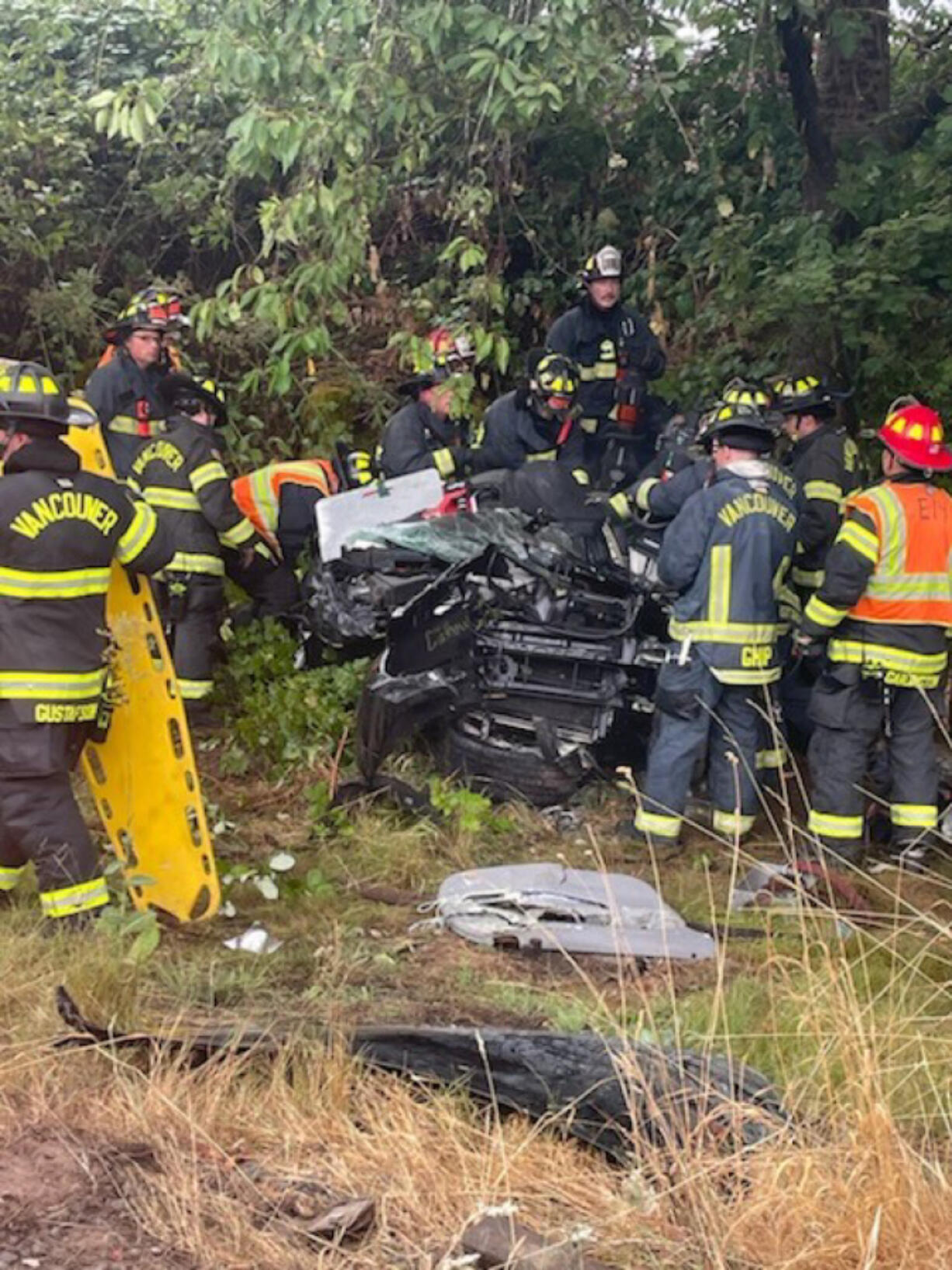 Vancouver firefighters extract a driver from a car that flipped on Highway 14 in east Vancouver on Monday afternoon.