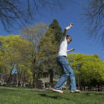 Jeff Way of Vancouver, right, keeps his balance as he enjoys slacklining in the sunshine with his roommate, Matthew Nebel, not pictured, Friday afternoon, April 1, 2016 at Esther Short Park. Yesterday's blue skies and warm temperatures made it a good day for residents to kick off their shoes and get outdoors. (Amanda Cowan/The Columbian)
