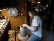 Tattooist-turned-potter Bradley Macom works on a vessel at his Vancouver studio. His arresting work combines ancient forms of Greek pottery with contemporary tattoo art.