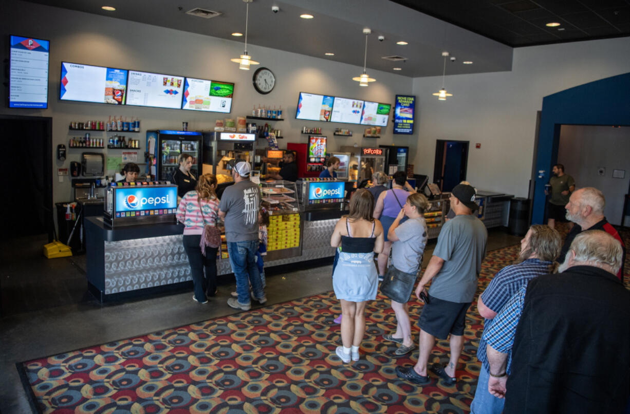 Moviegoers line up to purchase concessions Wednesday at Battle Ground Cinema. Ticket sales at the theater haven&rsquo;t quite reached pre-pandemic levels but are only 15 percent behind.