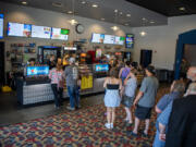 Moviegoers line up to purchase concessions Wednesday at Battle Ground Cinema. Ticket sales at the theater haven&rsquo;t quite reached pre-pandemic levels but are only 15 percent behind.