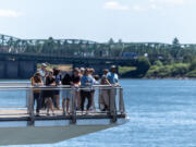 People stand out on the Grant Street Pier on Tuesday at The Waterfront Vancouver. Triple-digit temperatures forecasted over the weekend could break records, which are currently in the mid- to upper 90s for July 4-6.