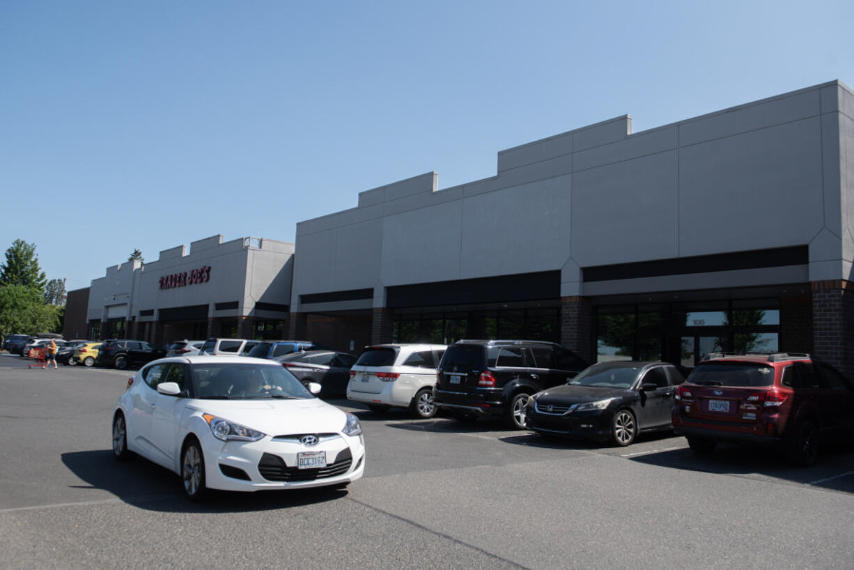 A motorist passes by the former locations of Dollar Tree, background left, and Party City, right, in east Vancouver on Thursday morning. Both retailers are among the nationwide chains that have closed at least one Clark County store.