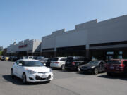 A motorist passes by the former locations of Dollar Tree, background left, and Party City, right, in east Vancouver on Thursday morning. Both retailers are among the nationwide chains that have closed at least one Clark County store.