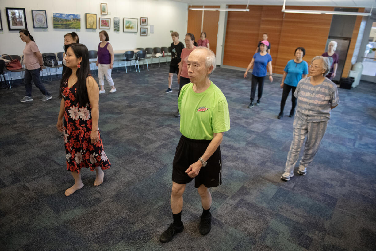 Vancouver resident Shyi-Hwang Shyu, foreground, keeps in step with other participants in a line dancing class at Cascade Park Community Library. Local libraries offer a treasure trove of fun, interesting and free things to do this summer.