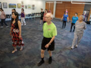 Vancouver resident Shyi-Hwang Shyu, foreground, keeps in step with other participants in a line dancing class at Cascade Park Community Library. Local libraries offer a treasure trove of fun, interesting and free things to do this summer.