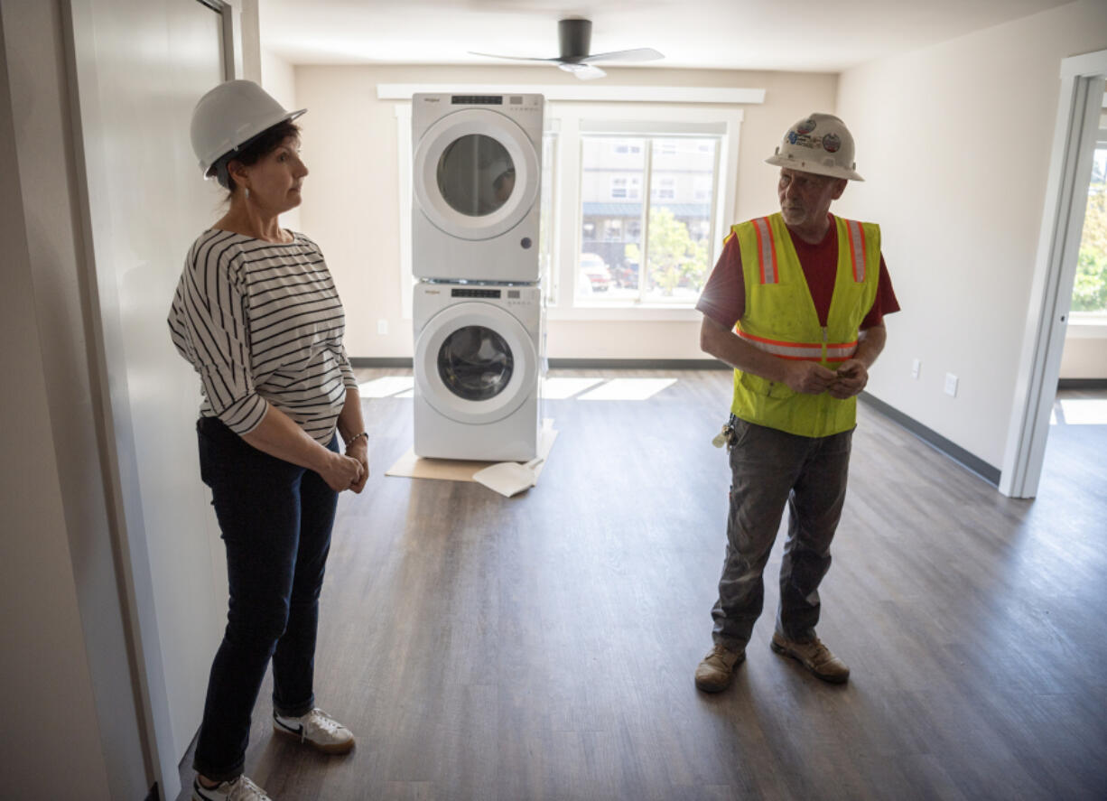 Robertson &amp; Olson Construction Superintendent Robert Baird, right, and Open House Ministries donor relations officer Jean Lacrosse stand in an unfinished apartment at OHM West, 1212 Jefferson St., expected to open this fall. At top, a rendering of OHM West, an affordable housing building for families in downtown Vancouver.