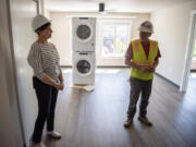 Robertson &amp; Olson Construction Superintendent Robert Baird, right, and Open House Ministries donor relations officer Jean Lacrosse stand in an unfinished apartment at OHM West, 1212 Jefferson St., expected to open this fall. At top, a rendering of OHM West, an affordable housing building for families in downtown Vancouver.
