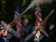 Sons of Union Veterans of the Civil War members Tony Pasillas, left, and Tim O&rsquo;Neal fire a musket salute as part of Sunday&rsquo;s ceremony for Civil War veteran Blandaman &ldquo;Blandy&rdquo; L. Smith at Brush Prairie Cemetery.