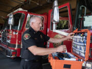 Robb Milano, Emergency Medical Services Division chief, adds a dose of Narcan to a medical kit at Vancouver Fire Department headquarters. The Vancouver Fire Department has launched a new leave-behind Narcan program. Narcan overdose prevention kits are provided to any individual who receives overdose treatment from Vancouver first responders.