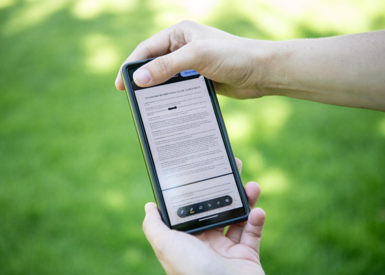 A single mother who was scammed out of an apartment displays the fake lease on her phone at Vancouver Community Library. Rental scams are becoming more prevalent as the affordable housing crisis gets worse.