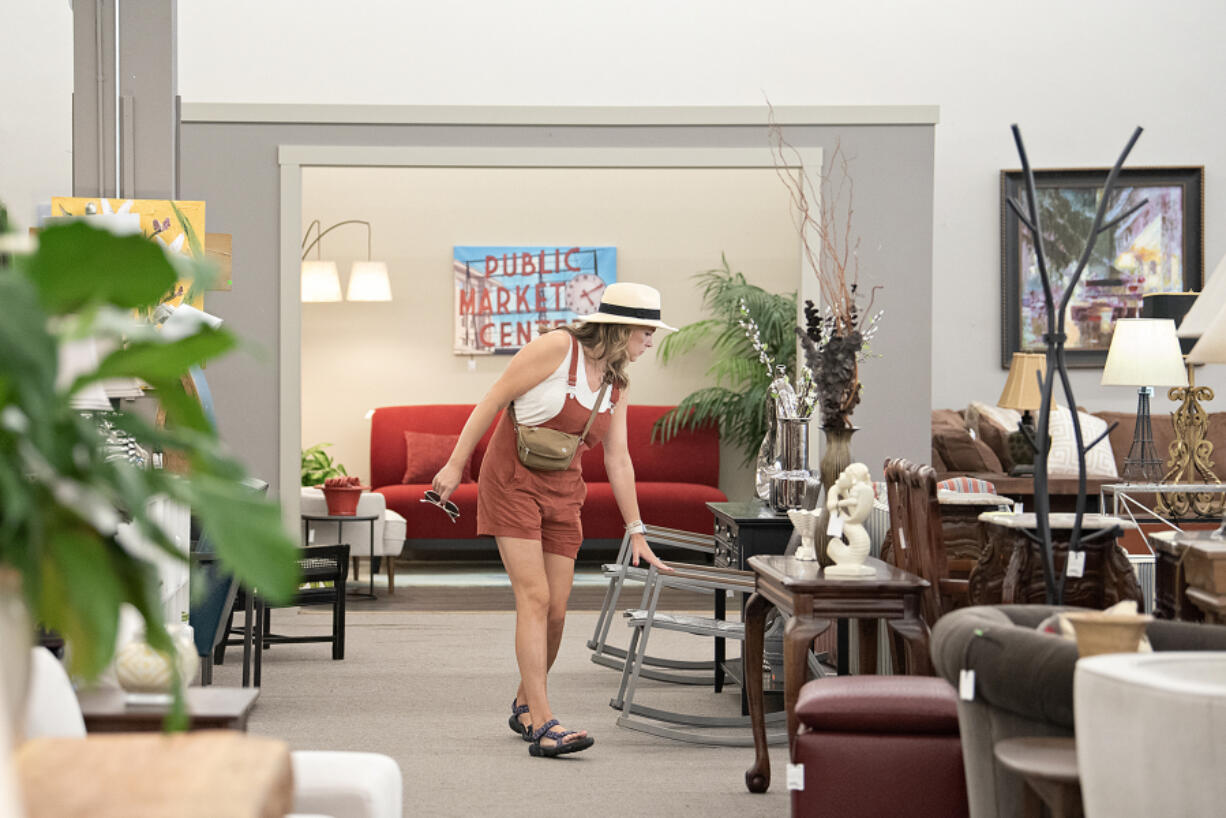 Ridgefield resident Stacie Urban browses the selection of furniture and artwork at Divine Consign in downtown Vancouver on Wednesday morning. Divine Consign is closing after almost 20 years.