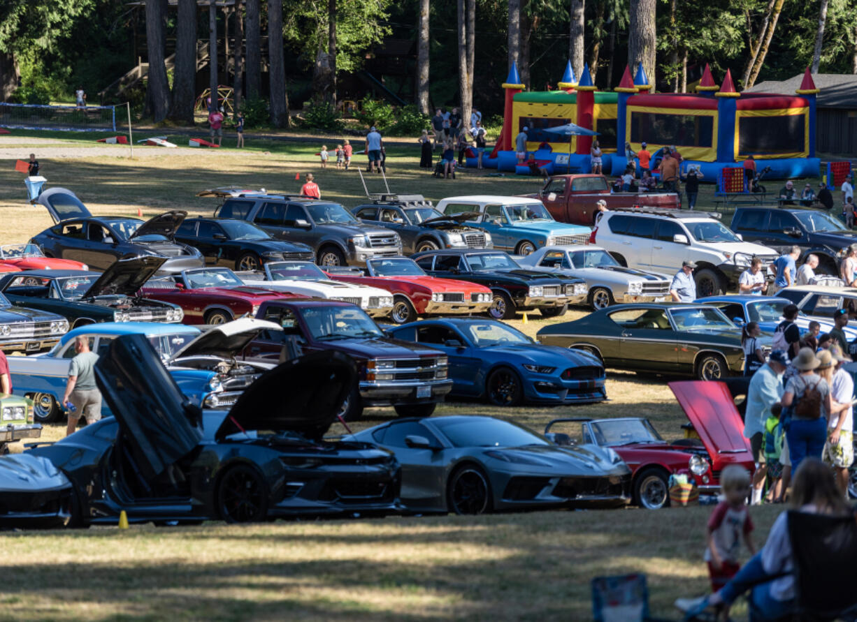 People stroll among classic cars Friday, during one of Alderbrook Park&rsquo;s regular Friday night cruise-ins.