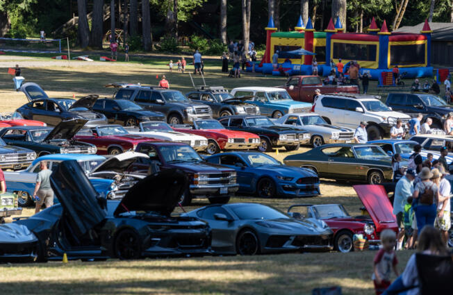People stroll among classic cars Friday, during one of Alderbrook Park&rsquo;s regular Friday night cruise-ins.