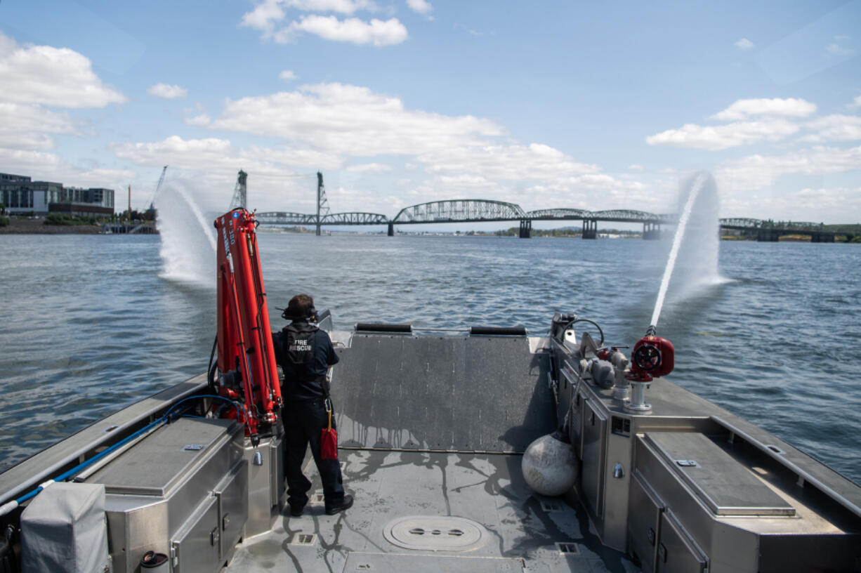 Water sprays out of cannons on the front of Vancouver Fire Boat 1 on Monday on the Columbia River. In the 10 years the department has had the boat, development along Vancouver&rsquo;s waterfront has increased the need for the emergency response vessel.