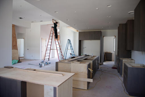 Tanner Hord of Service First Heating and Cooling works on a house that will be part of the next Parade of Homes in Felida. Housing trends have changed in the past two decades, with kitchens larger than they used to be.