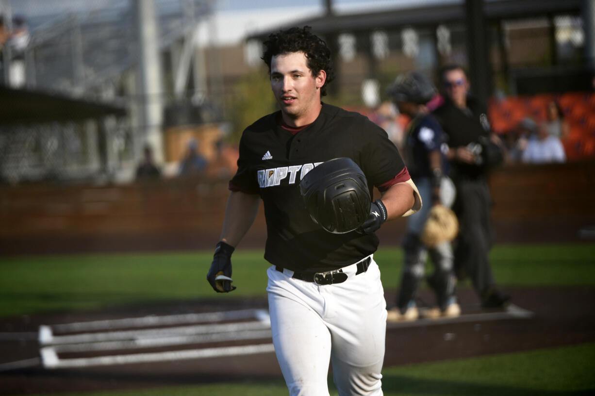 Hunter Katschke of the Ridgefield Raptors returns to the dugout after hitting a two-run home run against the Victoria HarbourCats in a West Coast League game at the Ridgefield Outdoor Recreation Center on Saturday, July 20, 2024 (Tim Martinez/The Columbian)