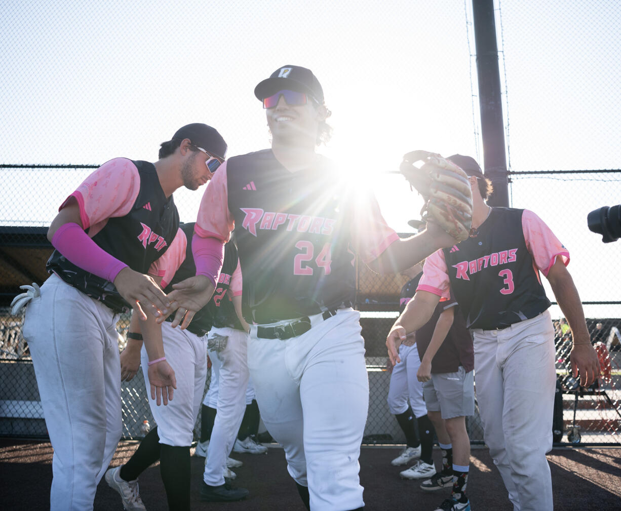 Ridgefield's Hunter Katschke (24) high fives teammates during pregame introductions Thursday, July, 25, 2024, before a game between the Raptors and the Corvallis Knights at the Ridgefield Outdoor Recreation Complex.