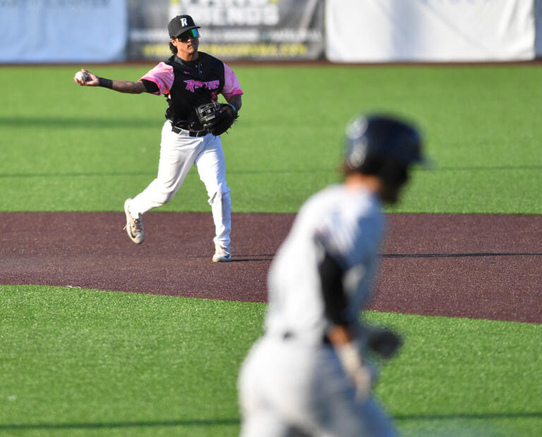 Ridgefield's Julian Nunez (15) throws toward first base Thursday, July, 25, 2024, during a game between the Raptors and the Corvallis Knights at the Ridgefield Outdoor Recreation Complex.