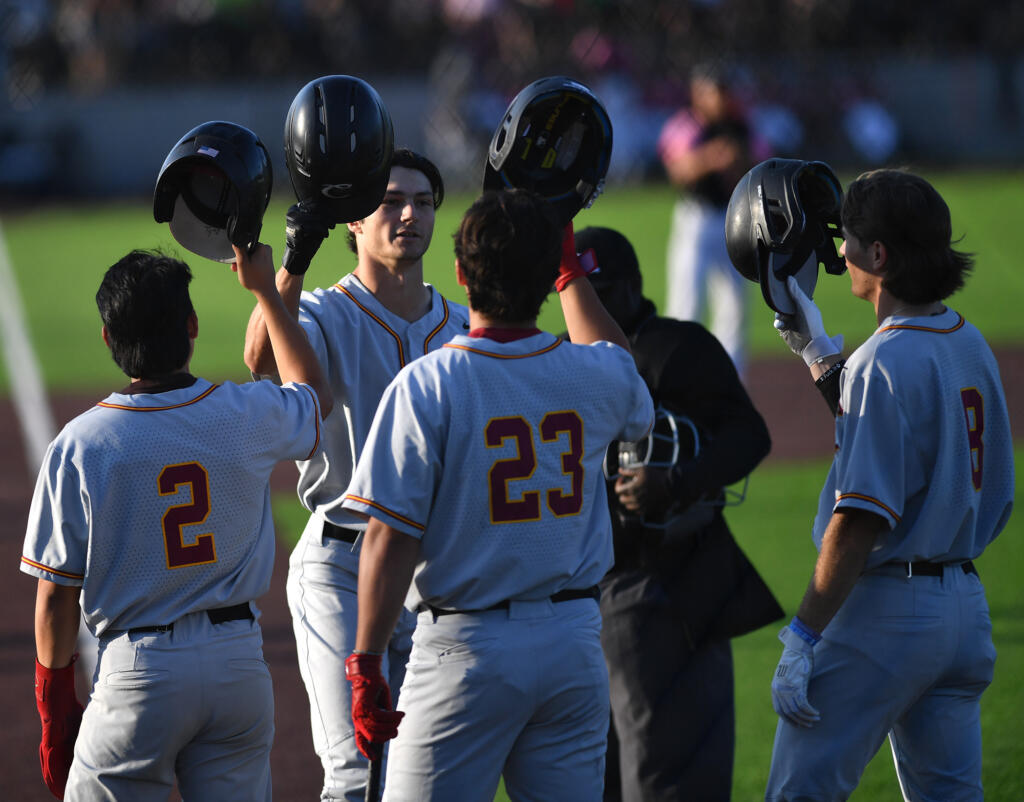 Corvallis’ Brandon Cabrera, second from left, celebrates with teammates after hitting a three-run home run Thursday, July, 25, 2024, during a game between the Ridgefield Raptors and the Corvallis Knights at the Ridgefield Outdoor Recreation Complex.