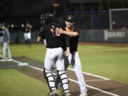 Cowlitz Black Bears pitcher Michael LeJeune (right) celebrates with catcher Ben Adams after the Black Bears beat the Ridgefield Raptors 6-5 in a West Coast League baseball game at David Story Field in Longview on Friday, July 26, 2024.