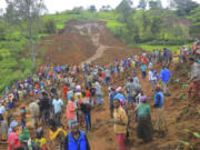 ADDS NAME OF THE PHOTOGRAPHER - In this handout photo released by Gofa Zone Government Communication Affairs Department, hundreds of people gather at the site of a mudslide in the Kencho Shacha Gozdi district, Gofa Zone, southern Ethiopia, Monday, July 22, 2024. At least 146 people were killed in mudslides in a remote part of Ethiopia that has been hit with heavy rainfall, according to local authorities.